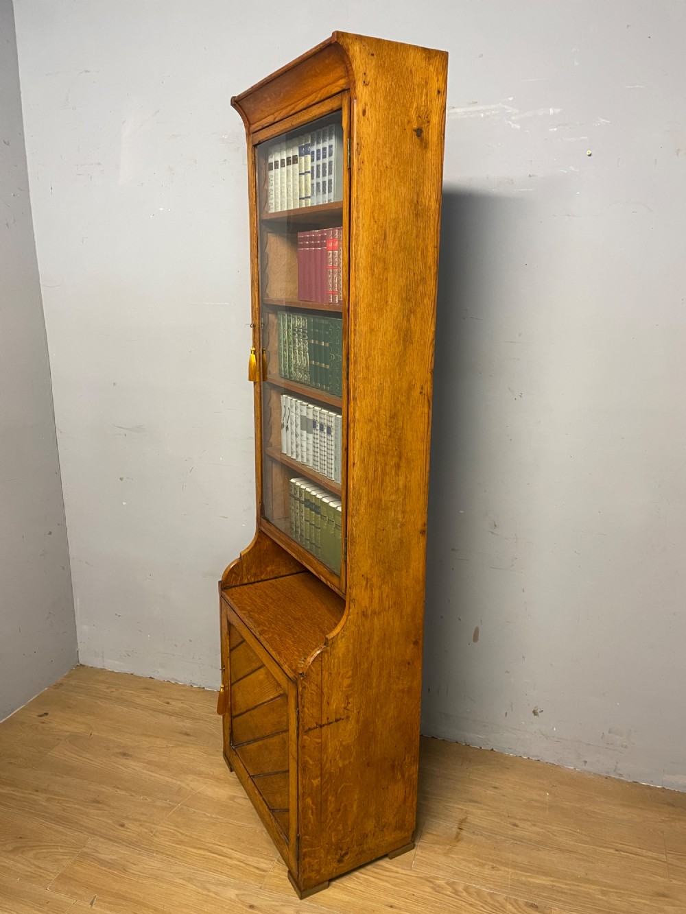 Arts and Crafts golden oak slim bookcase over cupboard View VIII