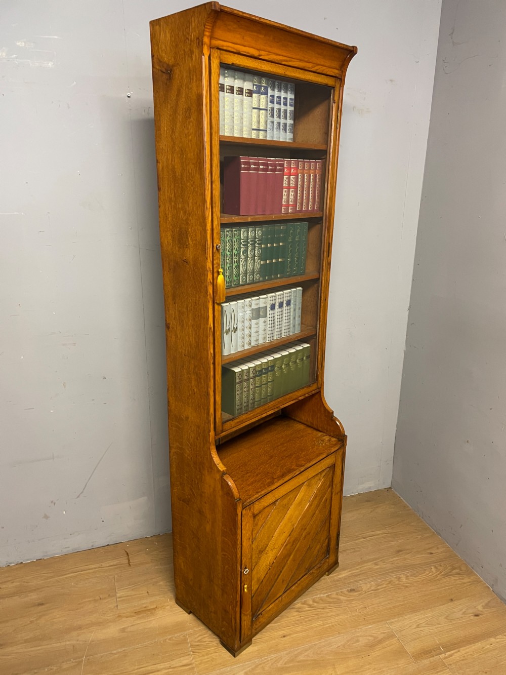 Arts and Crafts golden oak slim bookcase over cupboard View IX