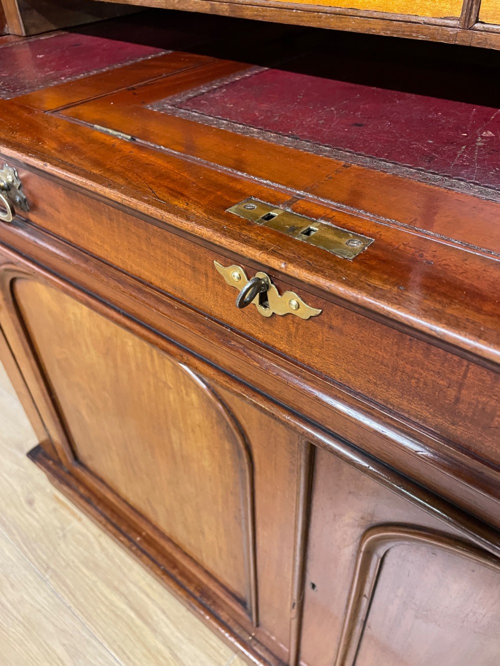 A 19th-century mahogany cylinder bureau bookcase featuring an upper glazed cabinet with two arched doors, a roll-top writing section, and a lower two-door cupboard. View VIII