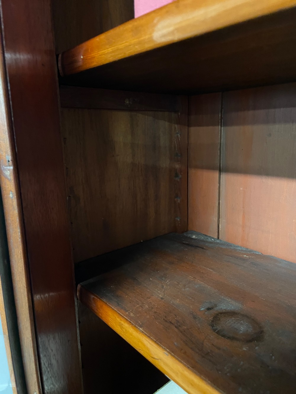 A 19th-century mahogany cylinder bureau bookcase featuring an upper glazed cabinet with two arched doors, a roll-top writing section, and a lower two-door cupboard. View X