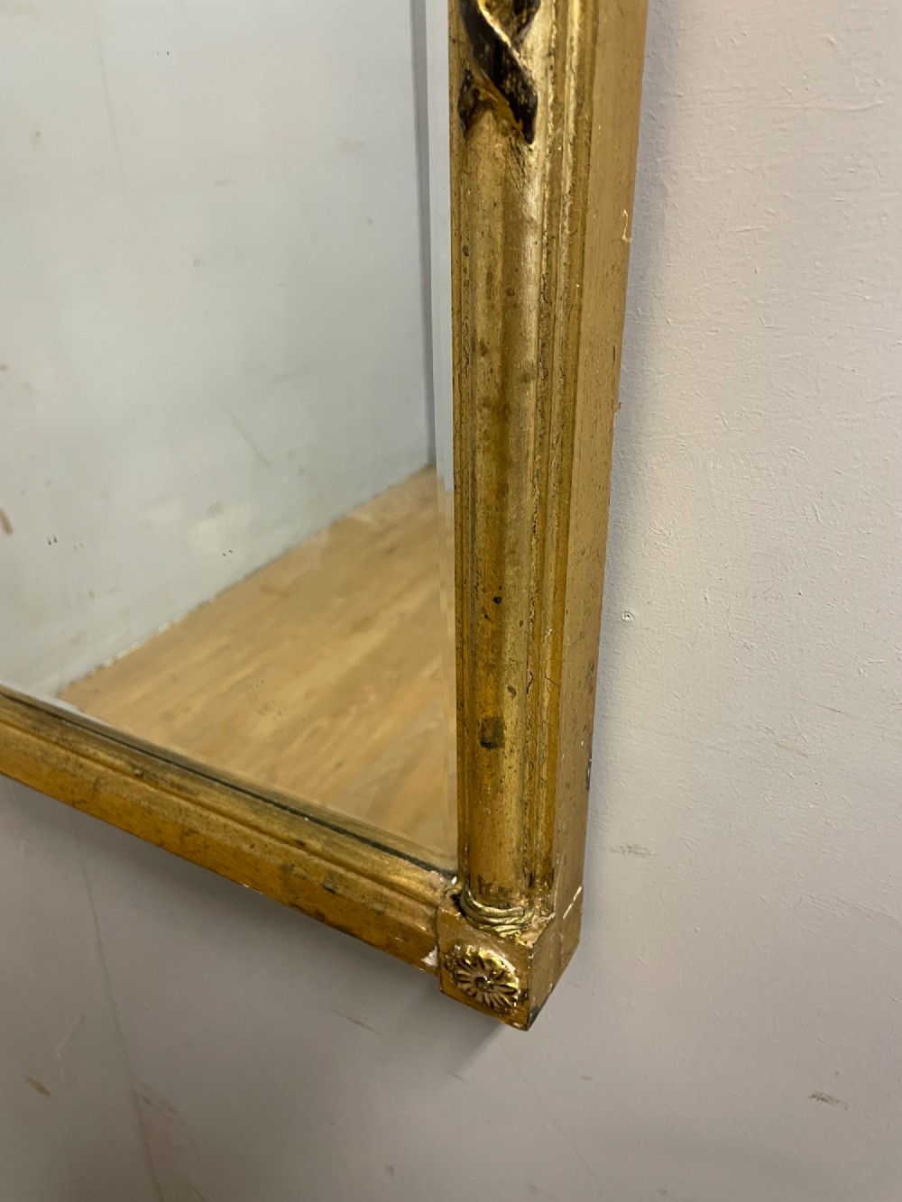 A rectangular giltwood wall mirror featuring a projecting cornice top, classical column pilasters, arcaded frieze details, and rosette corner blocks. View IV