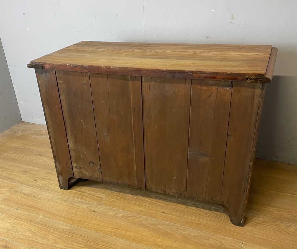 An Arts and Crafts solid ash chest of drawers featuring two short drawers over two long drawers with brass drop handles and dark linear inlay. View VIII
