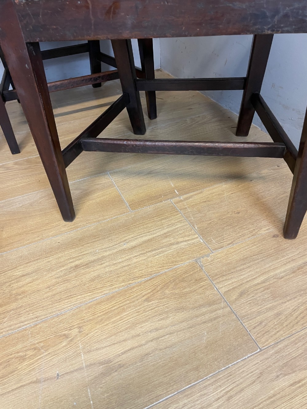 A set of six late Georgian dark mahogany country-made dining chairs featuring vertical bar backs and padded light tan upholstered drop-in seats. View X