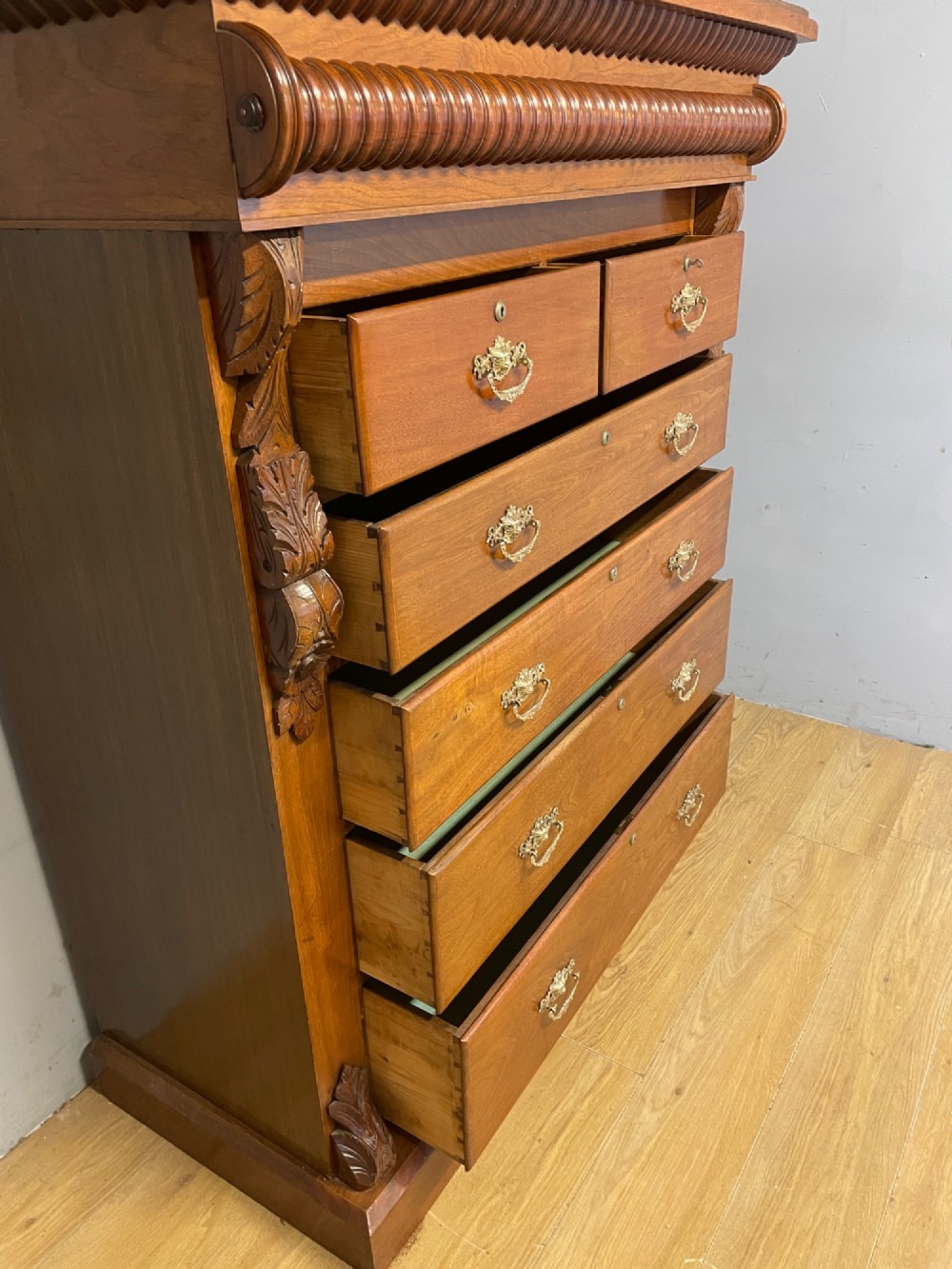 A 19th-century Scottish walnut chest of drawers featuring carved acanthus corbels, a gadrooned top frieze, and ornate brass drop handles. View VIII