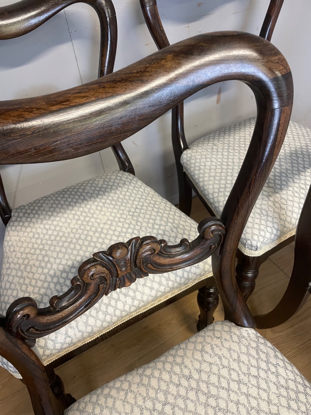 A set of four Victorian rosewood balloon back dining chairs with carved mid-rails, turned front legs, and grey patterned upholstered seats. View VIII