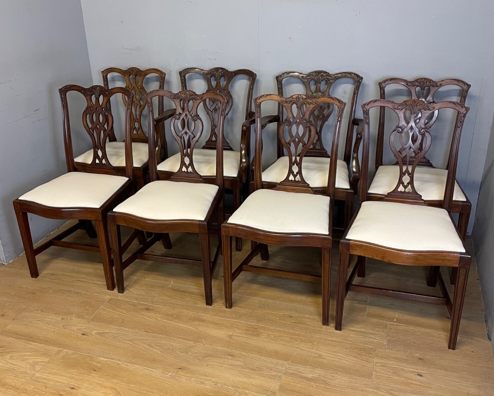 A set of eight solid mahogany Chippendale style dining chairs with intricate carved pierced splats and light cream drop-in seats. View II