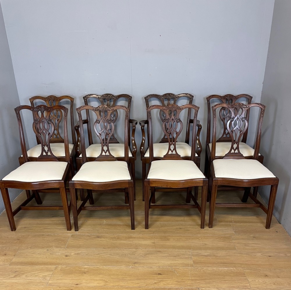 A set of eight solid mahogany Chippendale style dining chairs with intricate carved pierced splats and light cream drop-in seats. View XIII