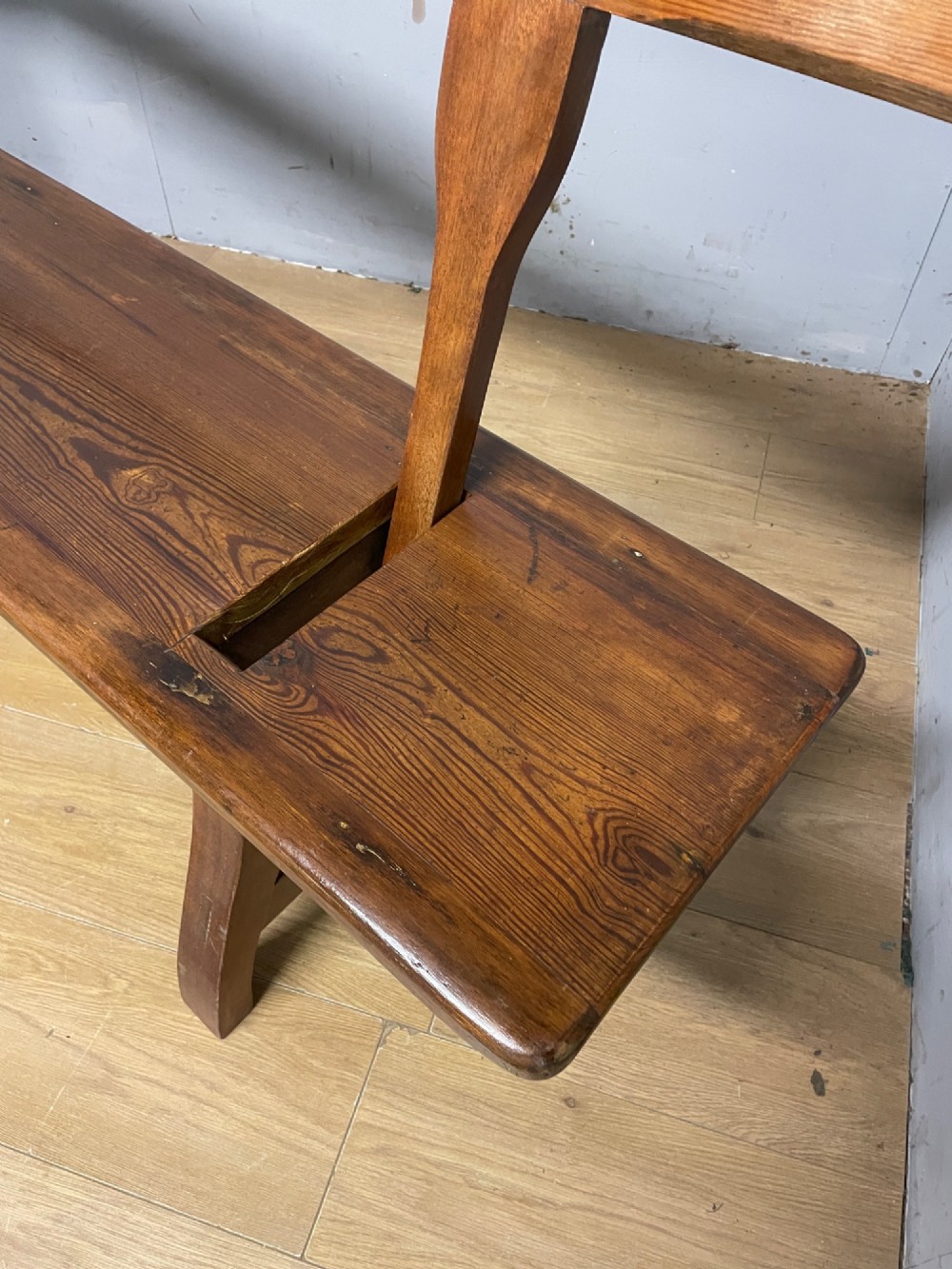 A Victorian pitch pine and mahogany bench featuring a long solid seat and a reversible swing backrest. View VIII