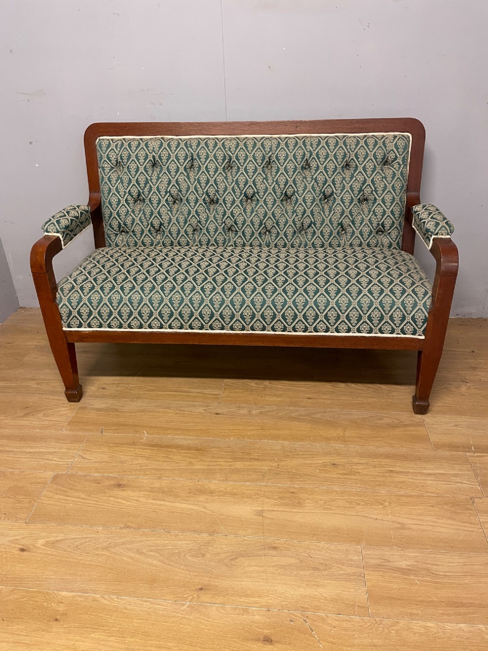 Late nineteenth-century mahogany frame two-seater sofa with deep buttoned green and cream patterned fabric upholstery. View II