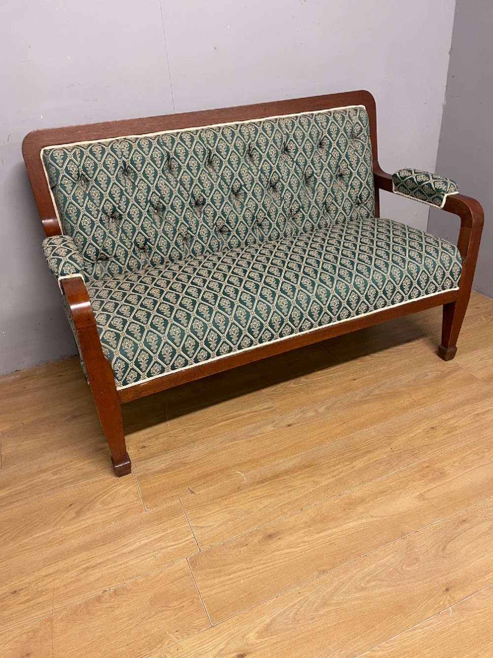 Late nineteenth-century mahogany frame two-seater sofa with deep buttoned green and cream patterned fabric upholstery. View III