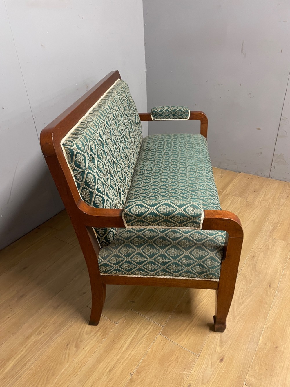 Late nineteenth-century mahogany frame two-seater sofa with deep buttoned green and cream patterned fabric upholstery. View V