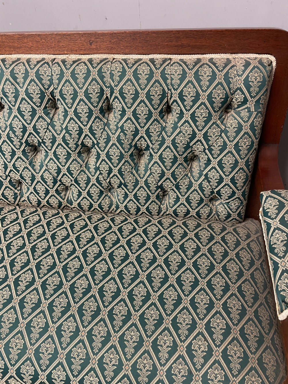 Late nineteenth-century mahogany frame two-seater sofa with deep buttoned green and cream patterned fabric upholstery. View VI