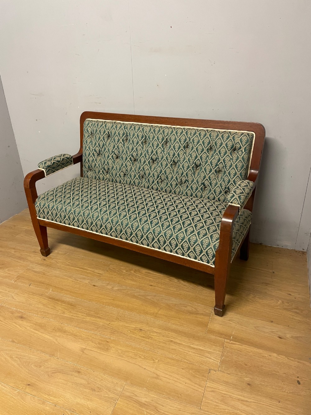 Late nineteenth-century mahogany frame two-seater sofa with deep buttoned green and cream patterned fabric upholstery. View IX