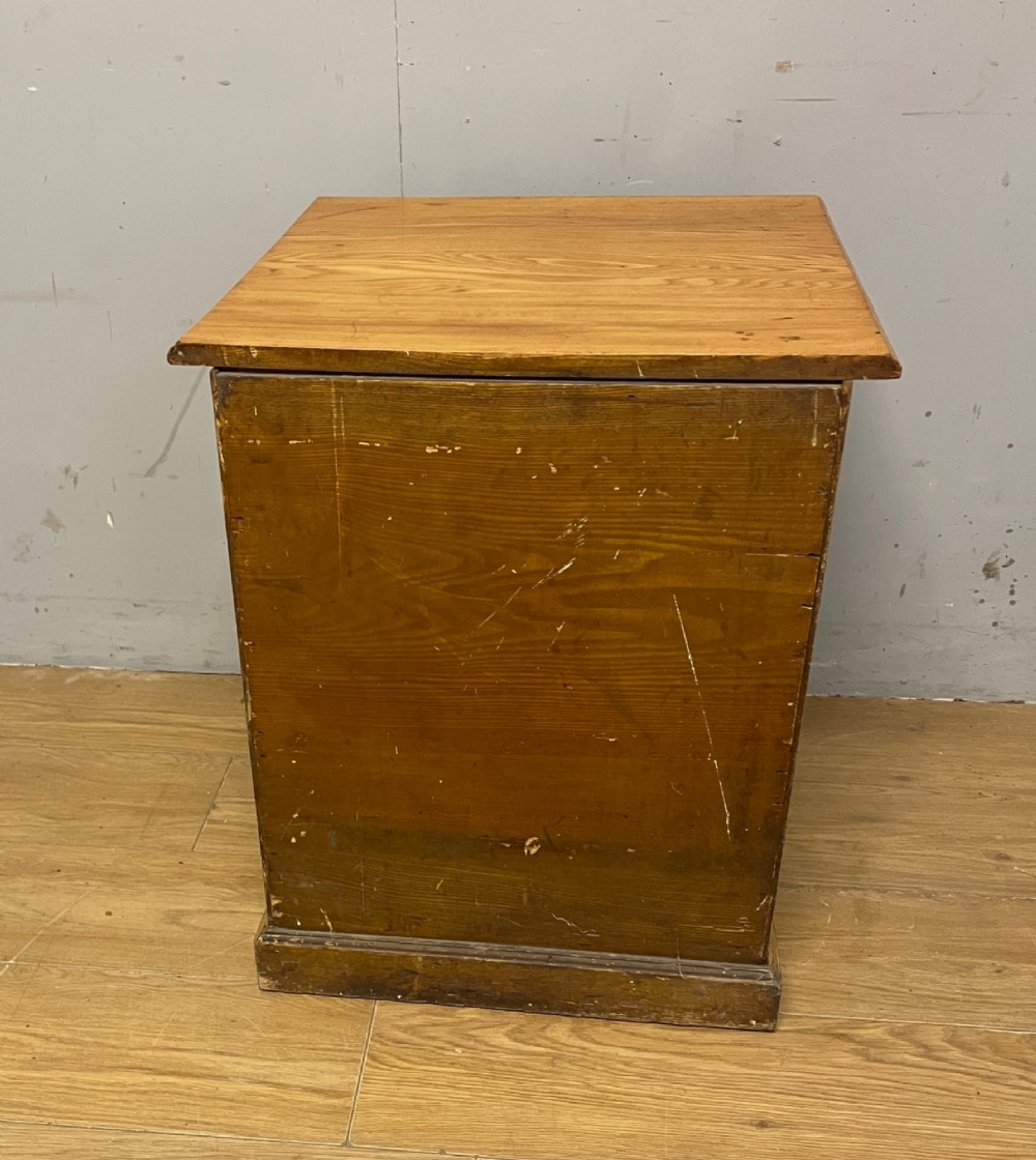 A late 19th-century small ash three-drawer chest featuring cast metal handles, brass keyhole escutcheons, a moulded edge top, and a solid plinth base. View VIII