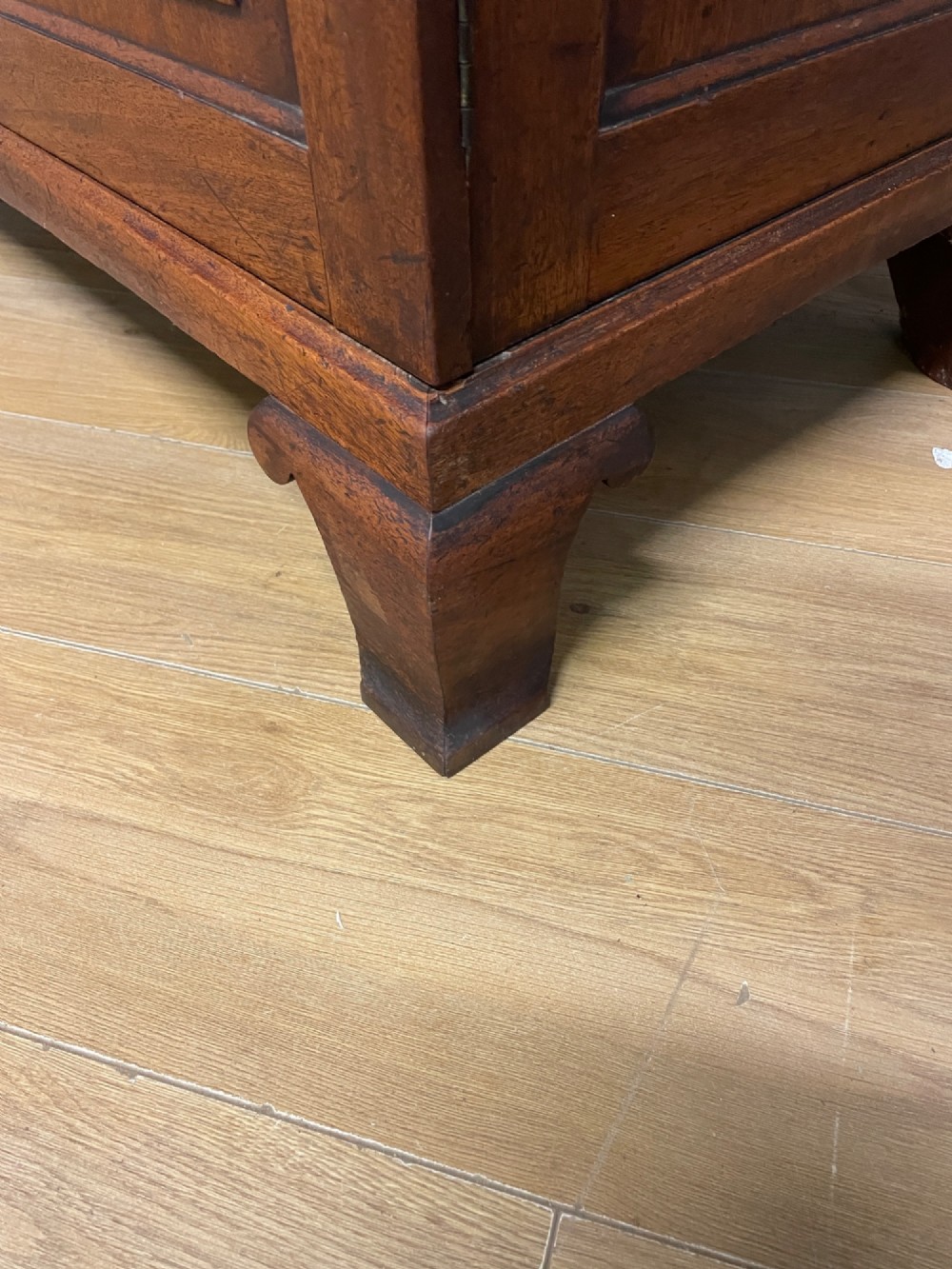 A nineteenth-century two-door flame mahogany wardrobe with panelled doors, brass escutcheons, and a moulded cornice. View XI