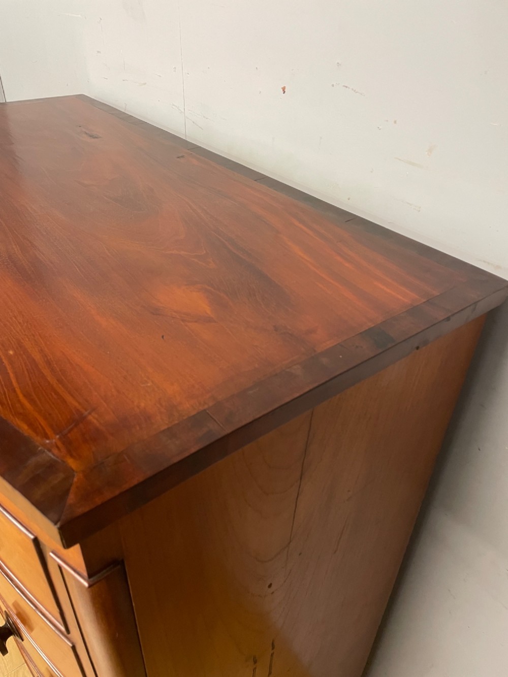 A 19th-century mahogany bow front chest of drawers featuring two short drawers over three long drawers with turned wooden handles. View VII