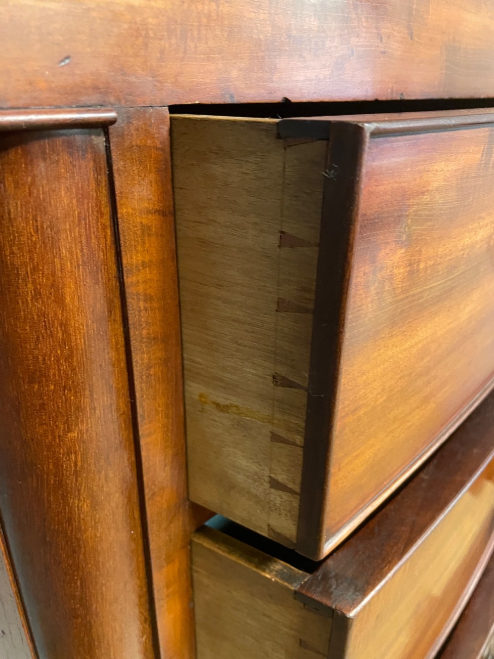 A 19th-century mahogany bow front chest of drawers featuring two short drawers over three long drawers with turned wooden handles. View IX