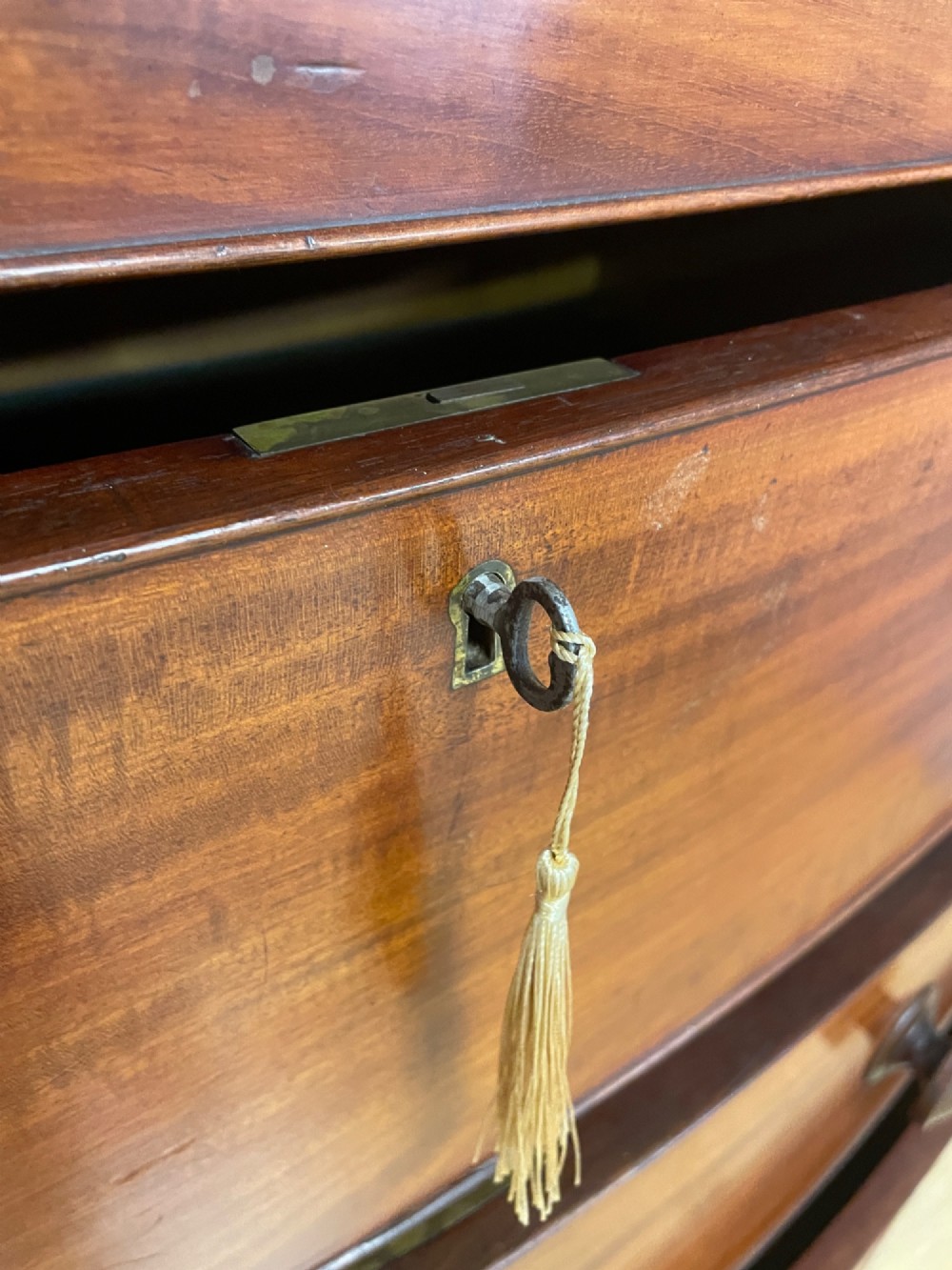 A 19th-century mahogany bow front chest of drawers featuring two short drawers over three long drawers with turned wooden handles. View X