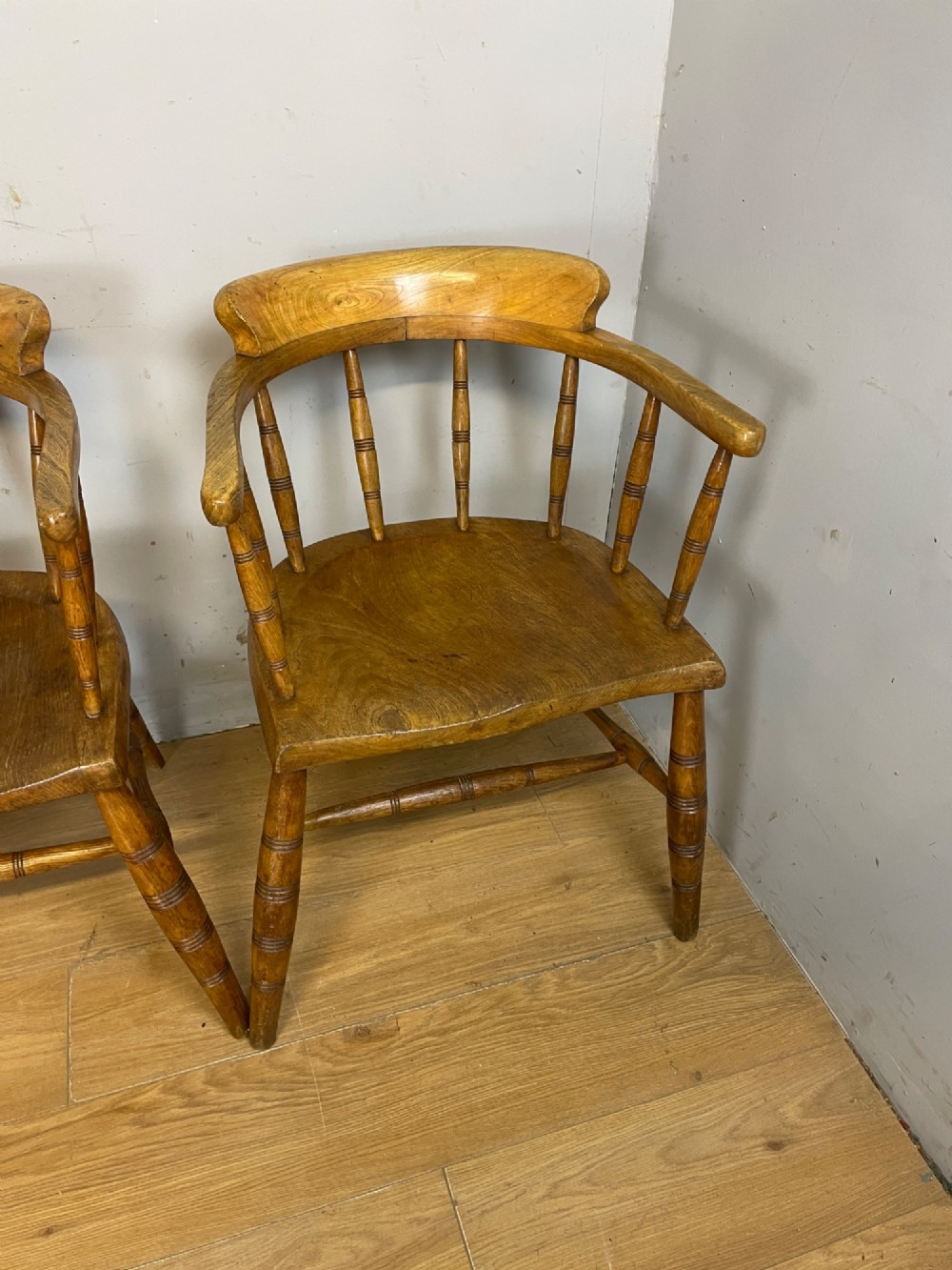 Set of four 19th-century bow back Windsor armchairs constructed from warm brown elm with turned spindle backs and legs. View III