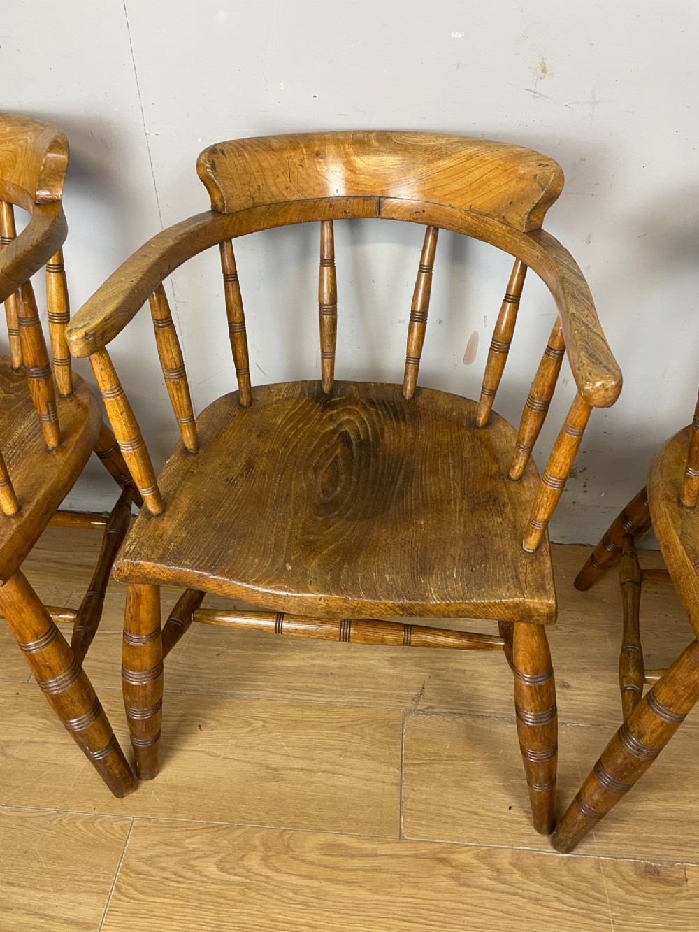 Set of four 19th-century bow back Windsor armchairs constructed from warm brown elm with turned spindle backs and legs. View VI