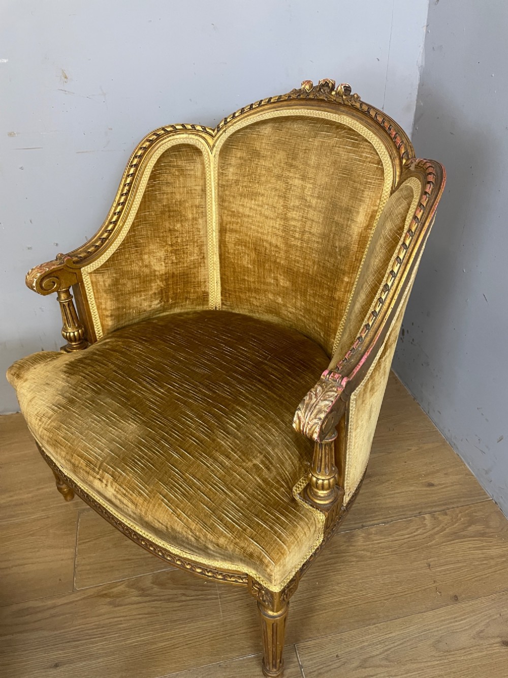 An Edwardian carved giltwood armchair with a matching rectangular footstool upholstered in gold velvet. View III