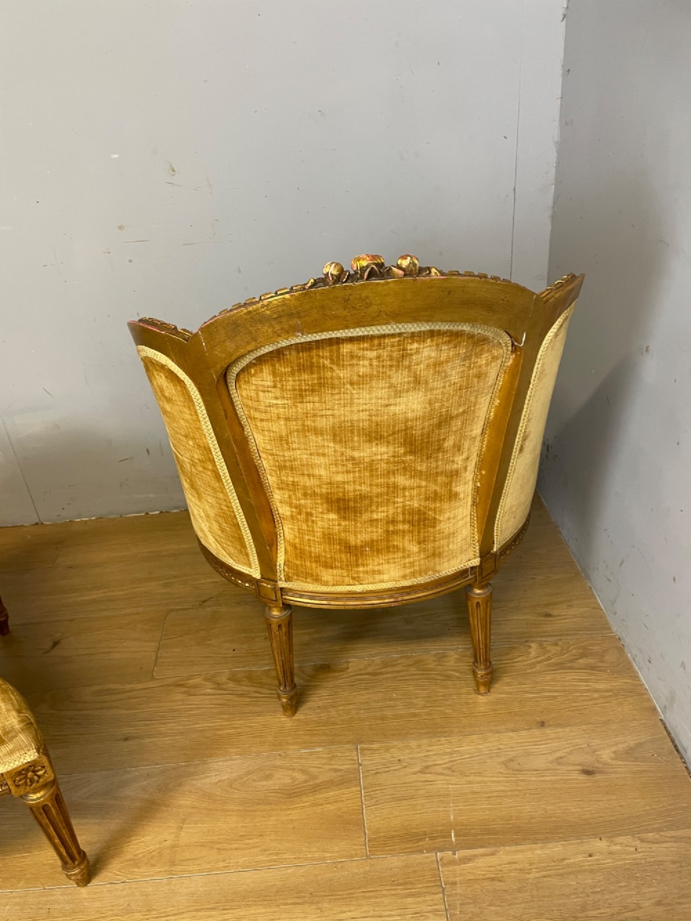 An Edwardian carved giltwood armchair with a matching rectangular footstool upholstered in gold velvet. View VI