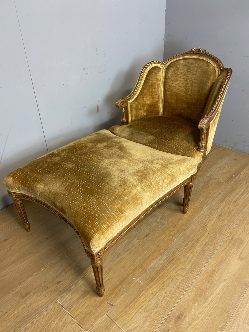 An Edwardian carved giltwood armchair with a matching rectangular footstool upholstered in gold velvet. View XI