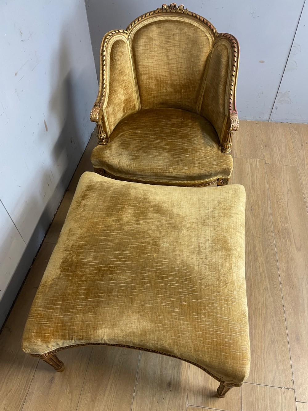 An Edwardian carved giltwood armchair with a matching rectangular footstool upholstered in gold velvet. View XII