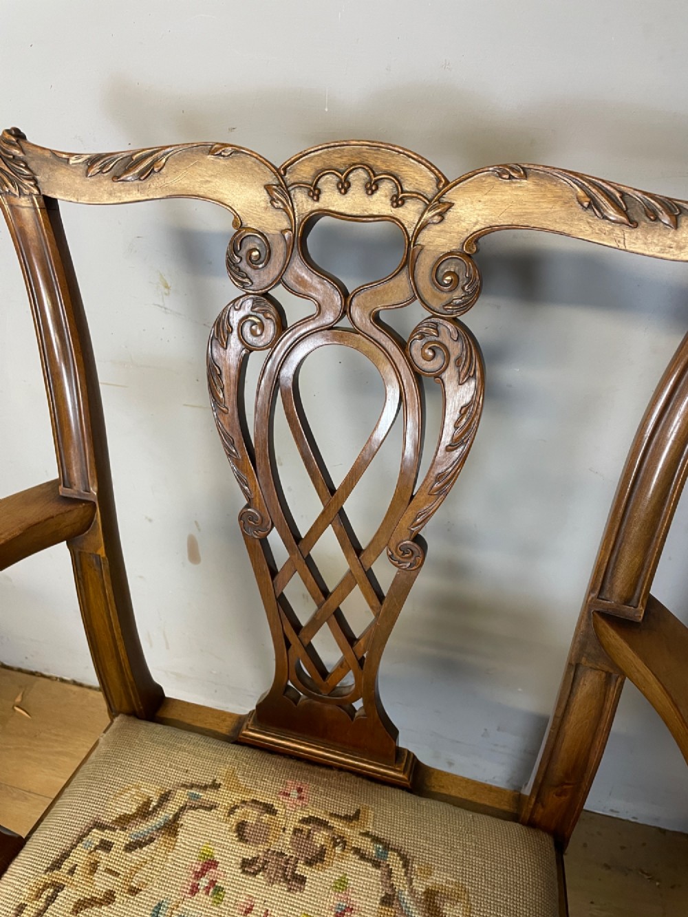A set of eight dark mahogany Chippendale Revival dining chairs featuring carved pierced back splats, tapestry seat pads, and cabriole legs with ball and claw feet. View VI
