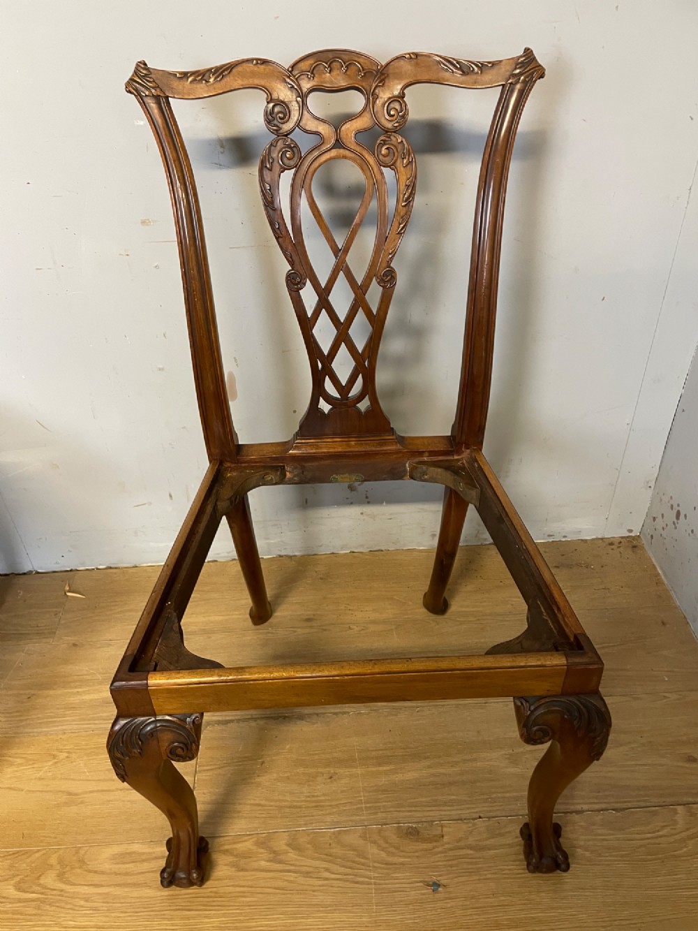 A set of eight dark mahogany Chippendale Revival dining chairs featuring carved pierced back splats, tapestry seat pads, and cabriole legs with ball and claw feet. View XI
