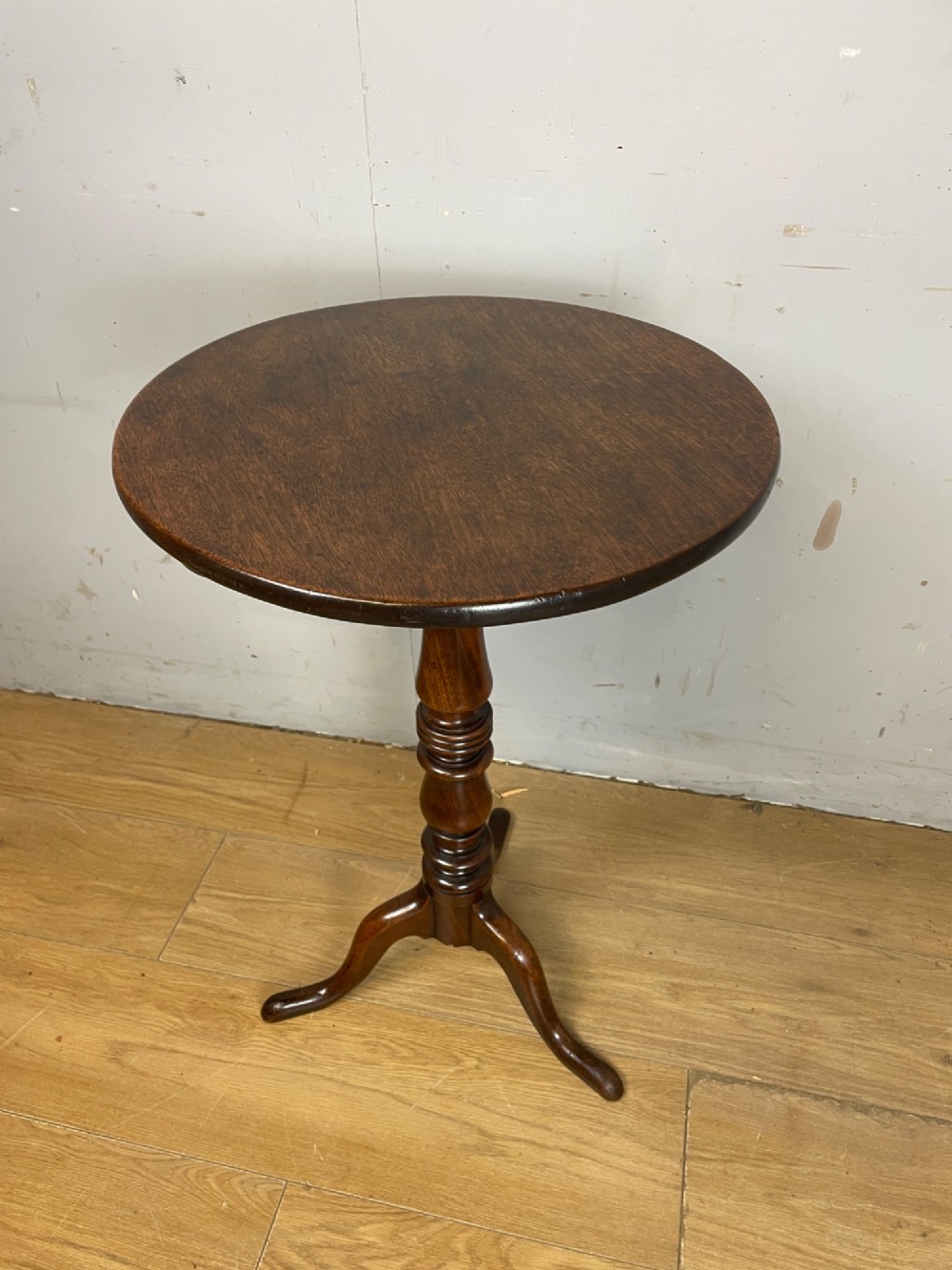 A Georgian mahogany wine table featuring a circular tilt top supported by a turned central pillar and three splayed legs. View III