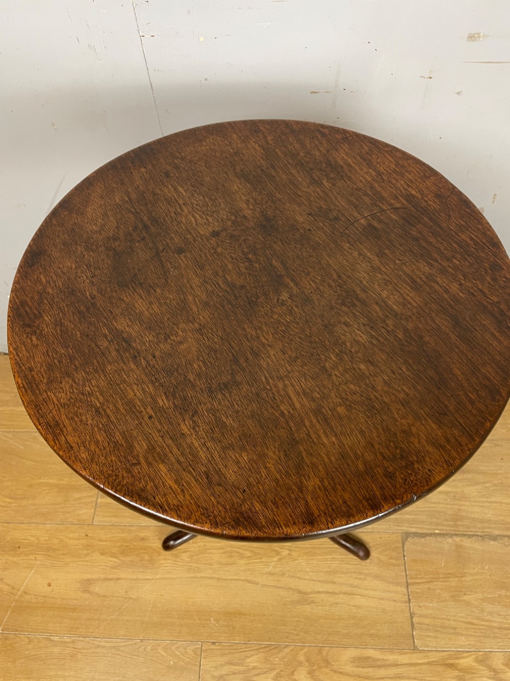 A Georgian mahogany wine table featuring a circular tilt top supported by a turned central pillar and three splayed legs. View IV