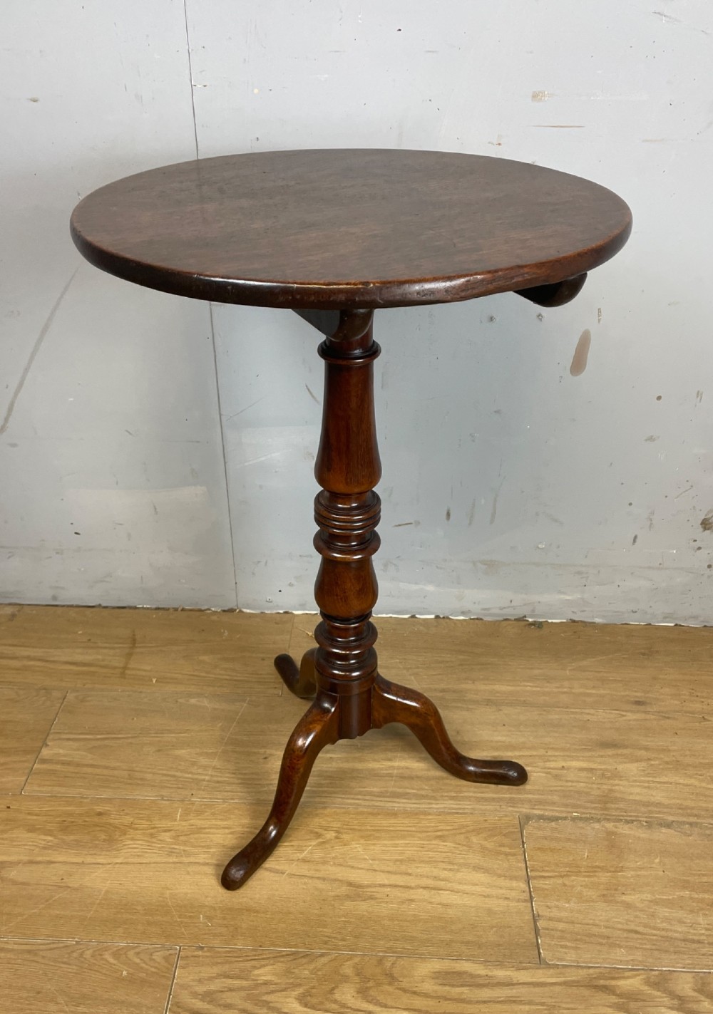 A Georgian mahogany wine table featuring a circular tilt top supported by a turned central pillar and three splayed legs. View VI