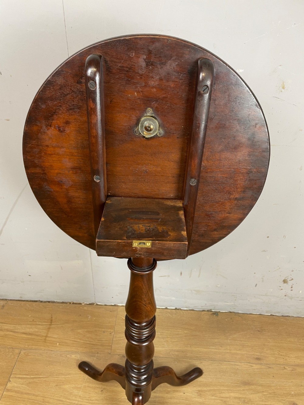 A Georgian mahogany wine table featuring a circular tilt top supported by a turned central pillar and three splayed legs. View VIII