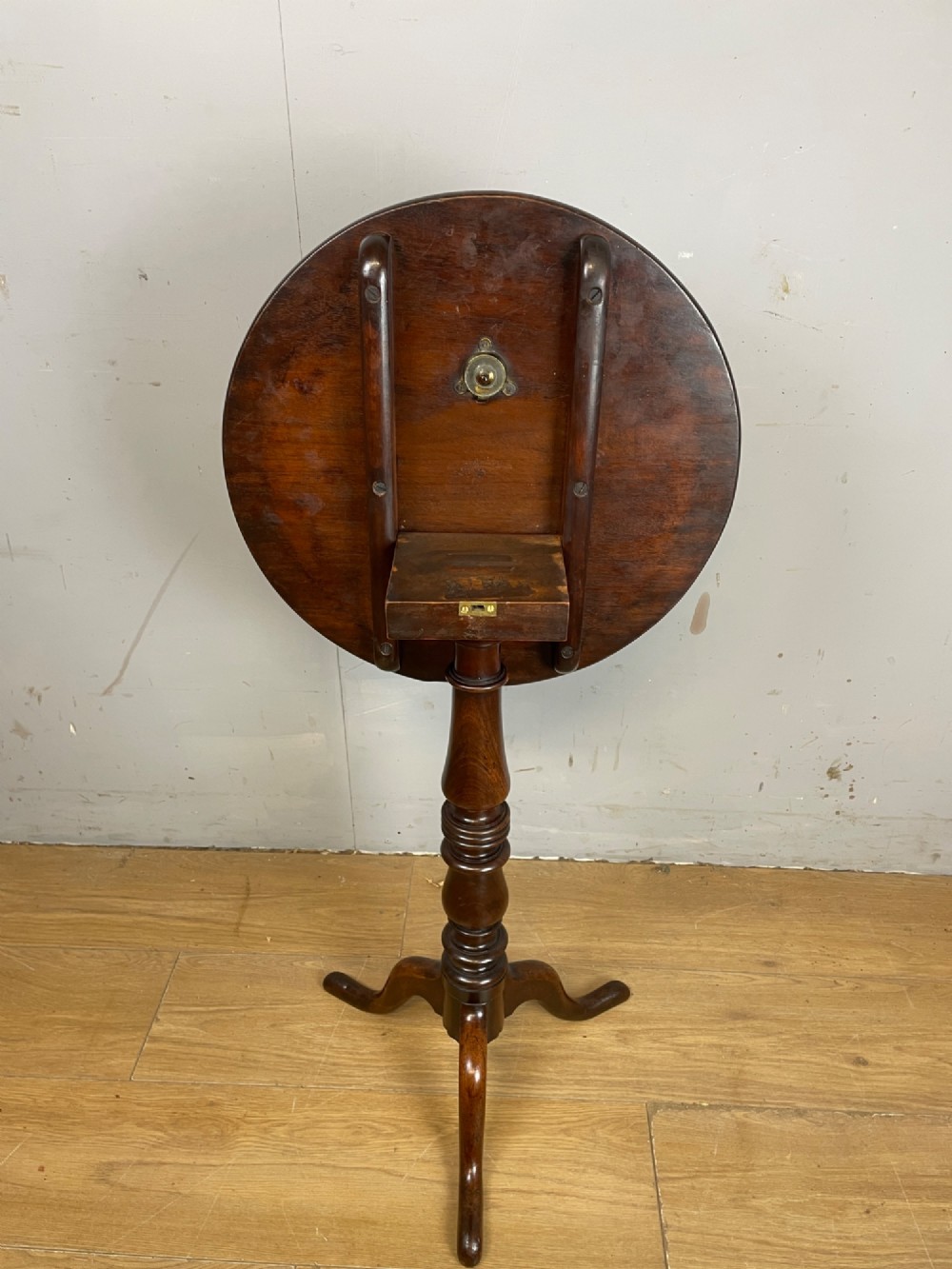 A Georgian mahogany wine table featuring a circular tilt top supported by a turned central pillar and three splayed legs. View IX
