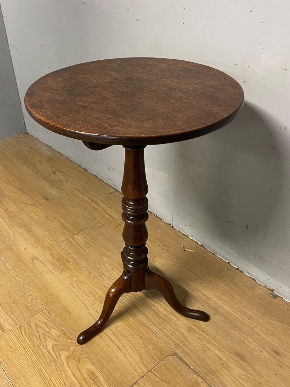 A Georgian mahogany wine table featuring a circular tilt top supported by a turned central pillar and three splayed legs. View XII