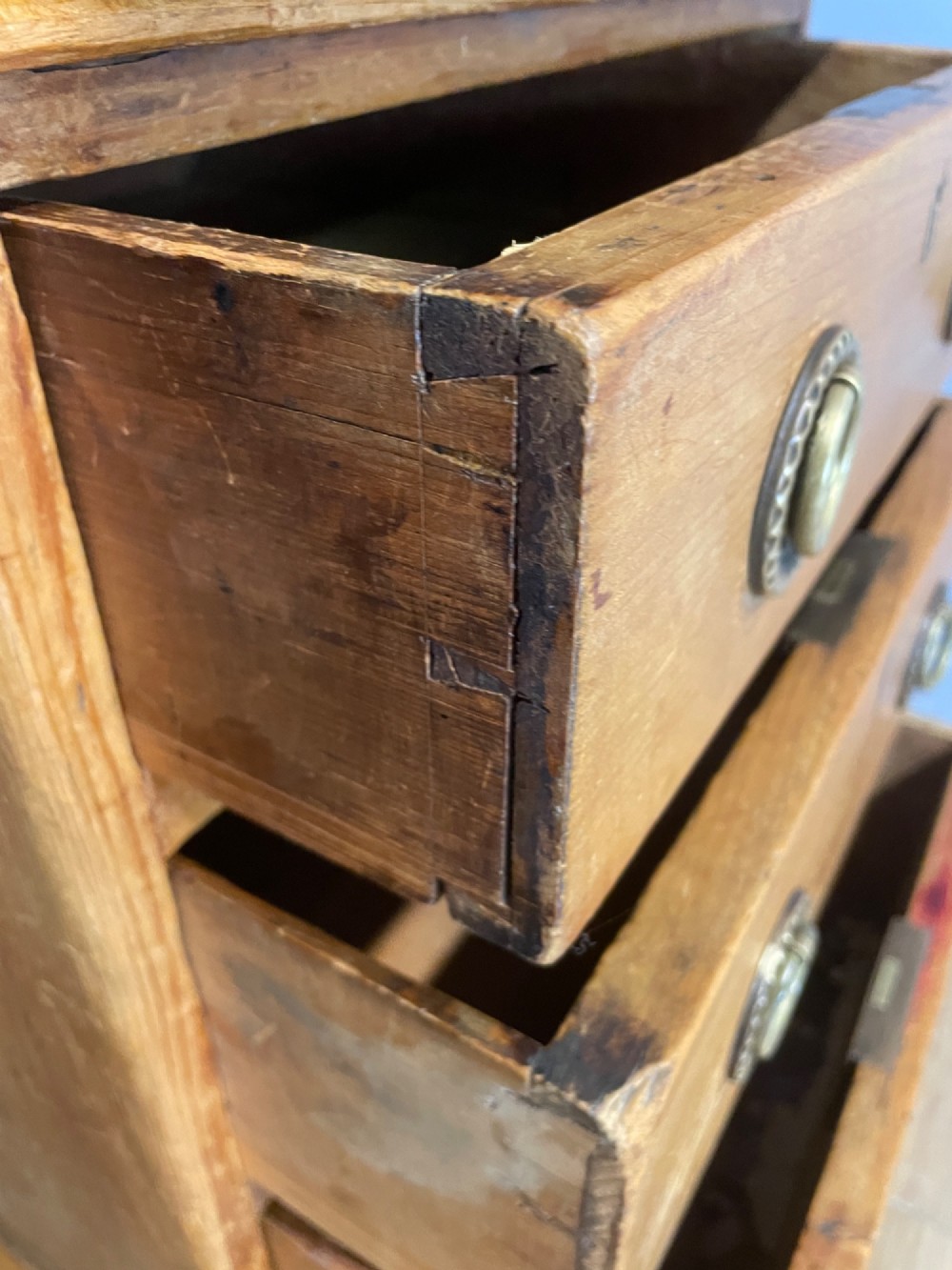 A Victorian three-part pine twin pedestal desk featuring a burgundy leather writing inset, multiple brass ring-pull drawers, and a plinth base. View X