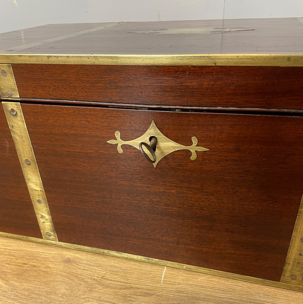A 19th-century mahogany campaign writing slope featuring brass corner mounts, candle holders, and a gold-tooled burgundy leather writing surface. View V