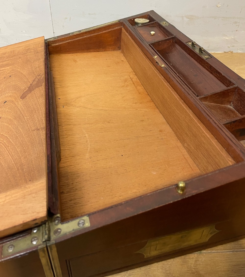 A 19th-century mahogany campaign writing slope featuring brass corner mounts, candle holders, and a gold-tooled burgundy leather writing surface. View VIII