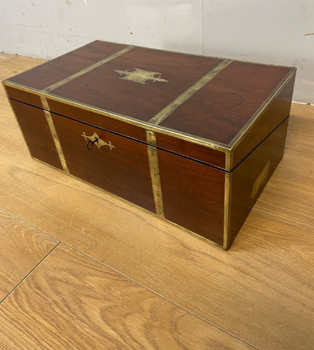 A 19th-century mahogany campaign writing slope featuring brass corner mounts, candle holders, and a gold-tooled burgundy leather writing surface. View XV