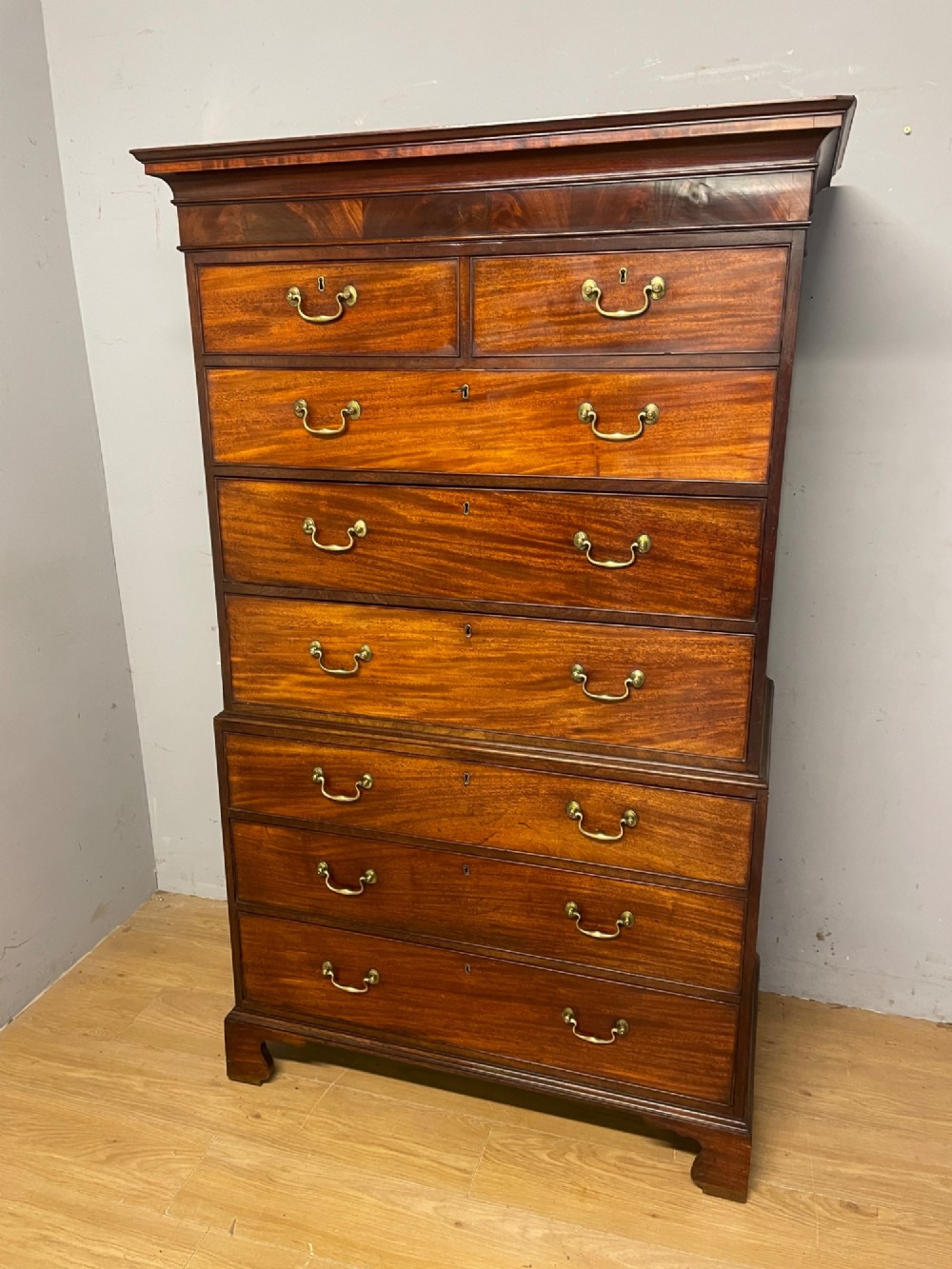 A late 18th-century mahogany chest on chest featuring two short drawers over six long drawers with brass handles and bracket feet. View III