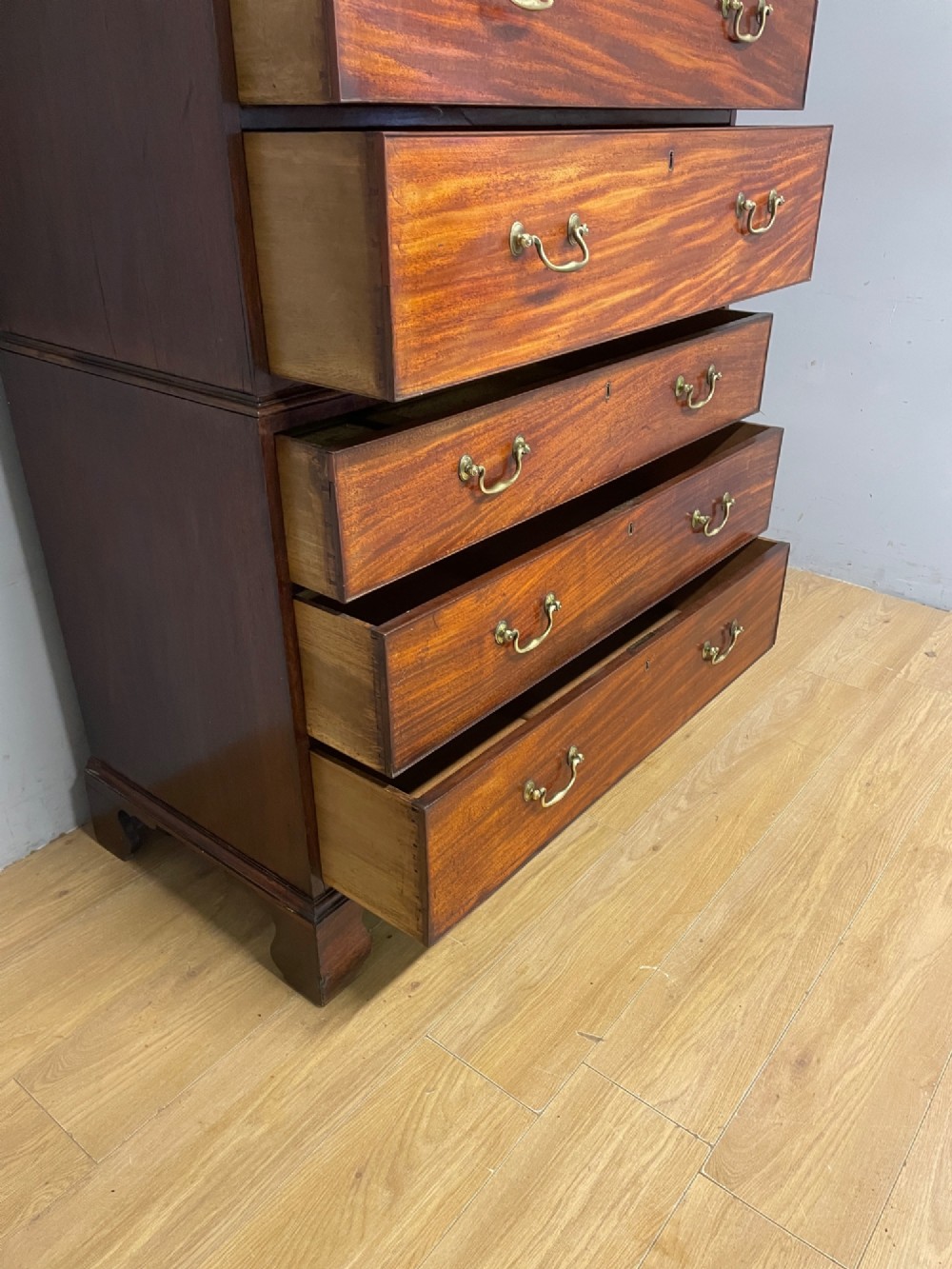 A late 18th-century mahogany chest on chest featuring two short drawers over six long drawers with brass handles and bracket feet. View X