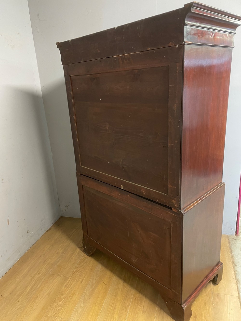 A late 18th-century mahogany chest on chest featuring two short drawers over six long drawers with brass handles and bracket feet. View XV