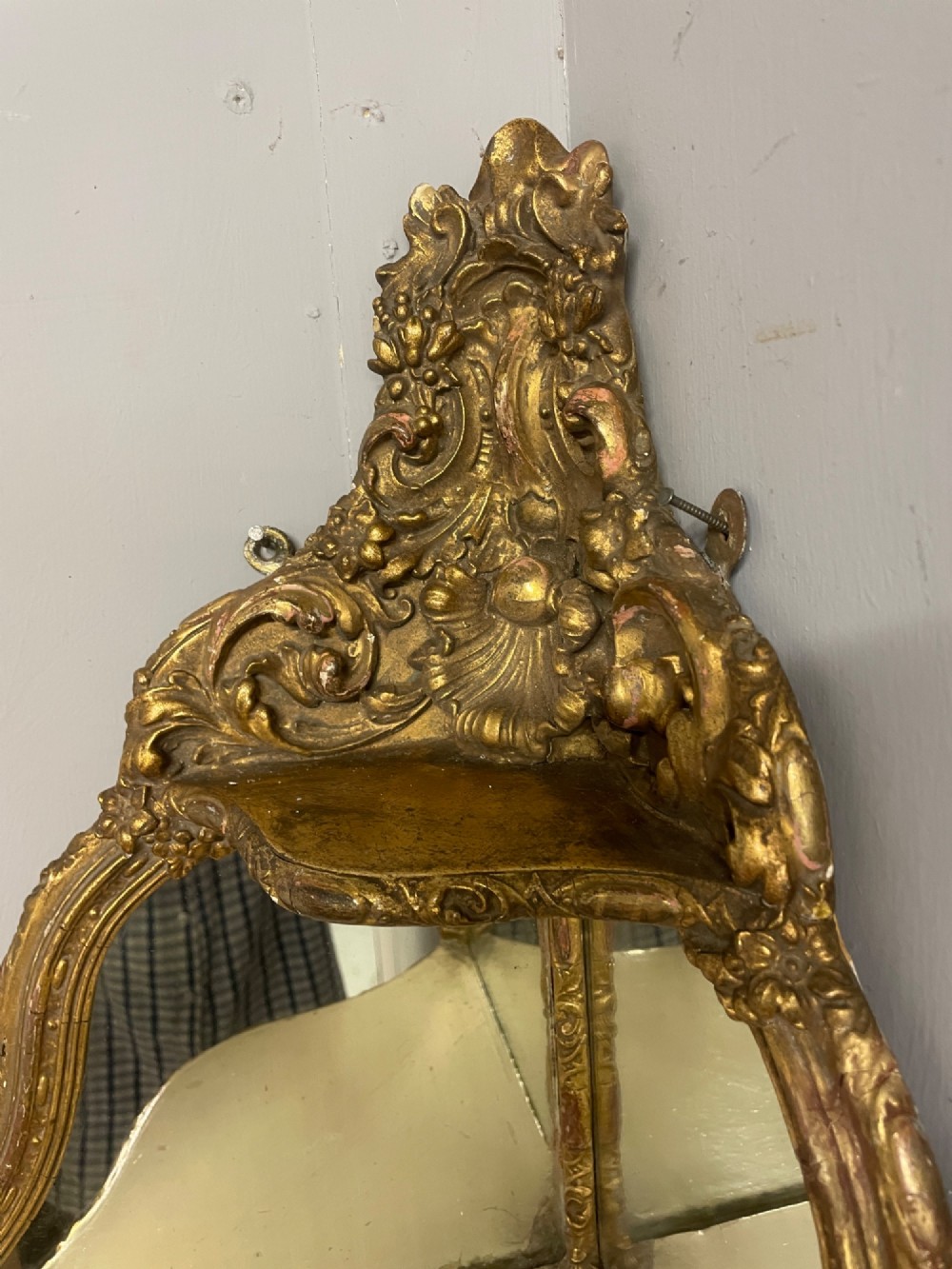 A 19th-century carved giltwood corner wall bracket featuring Rococo scrolling foliage, mirrored back plates, and tiered display shelves. View II