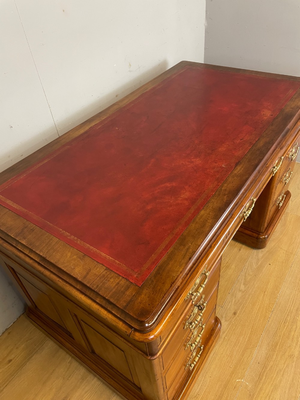 A 19th-century walnut twin pedestal desk featuring a red leather writing insert and brass drop handles. View III