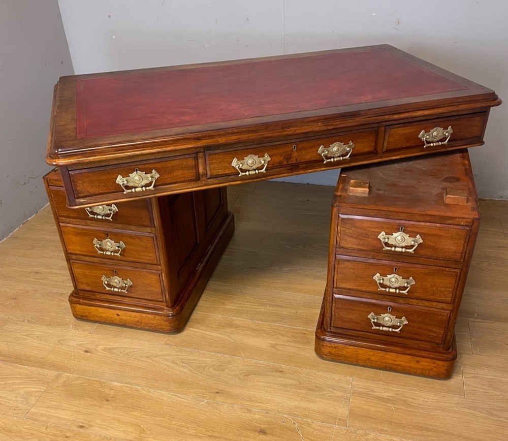 A 19th-century walnut twin pedestal desk featuring a red leather writing insert and brass drop handles. View XIII