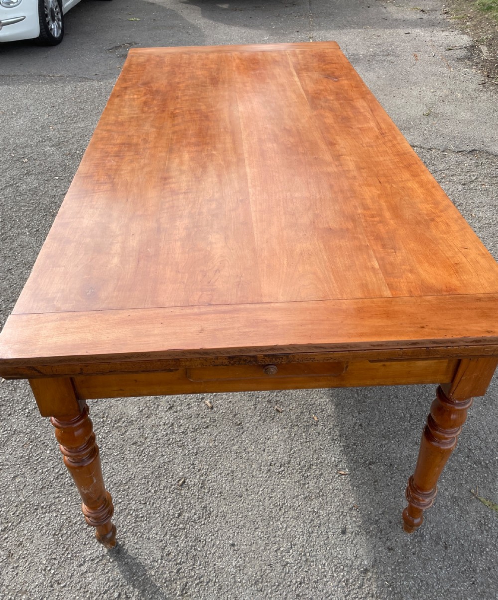A 19th-century French cherrywood extending dining table featuring turned legs and a polished rectangular top. View III