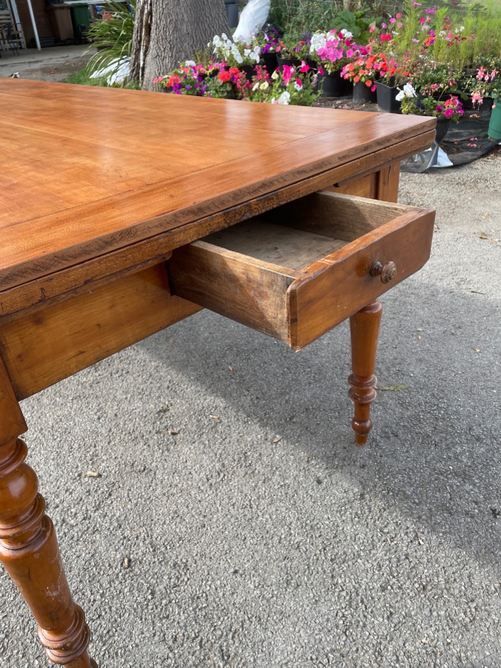 A 19th-century French cherrywood extending dining table featuring turned legs and a polished rectangular top. View IV