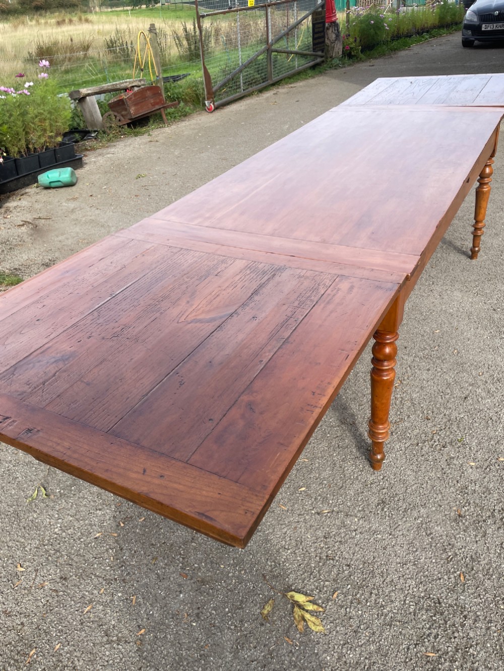 A 19th-century French cherrywood extending dining table featuring turned legs and a polished rectangular top. View VII
