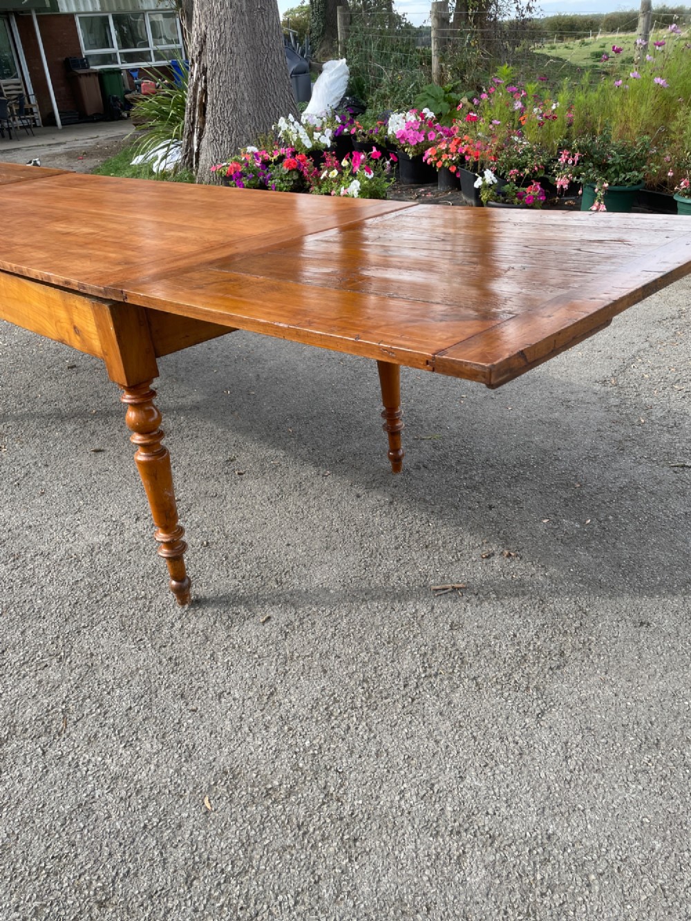 A 19th-century French cherrywood extending dining table featuring turned legs and a polished rectangular top. View IX